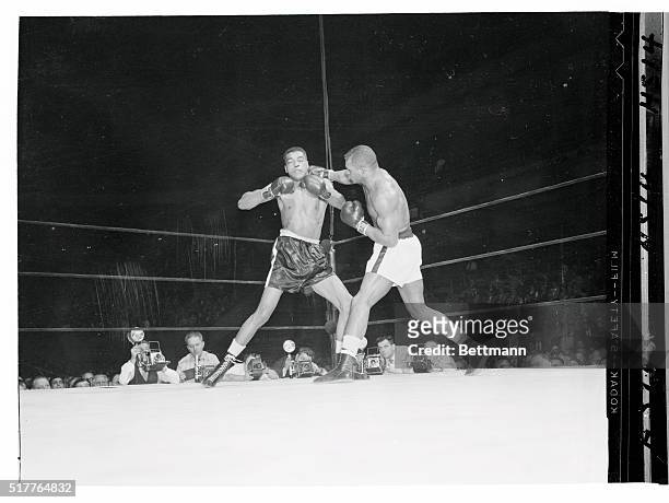Paul Andrews, , winces as he takes a right to the neck from Harold Johnson in the 6th round of their scheduled ten round light heavyweight bout at...