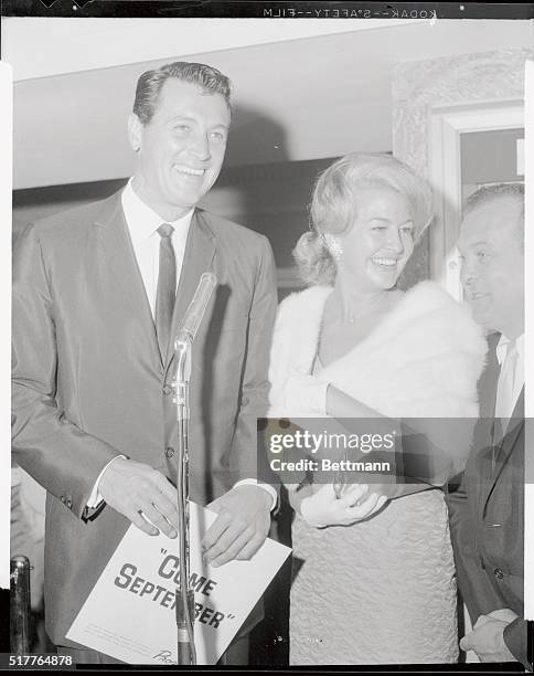 Rock hudson with Marilyn Maxwell as they arrived at the Beverly Theatre here for the premiere of Come September in which hudson co-stars with Gina...