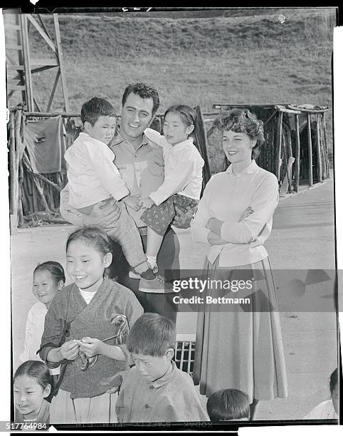 Hollywood, California: The Rock Hudsons Entertain Korean Tots On studio Set. Actor Rock Hudson, and his wife, the former Phyllis Gates are shown on...