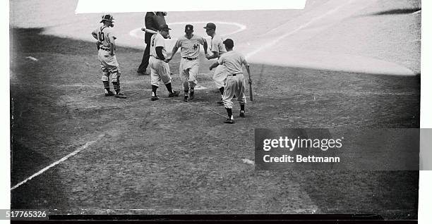 Yankee slugger Mantle gets glad hand at the plate after pulling his 44th homer of the season in the fourth inning of today's game with the Chicago...