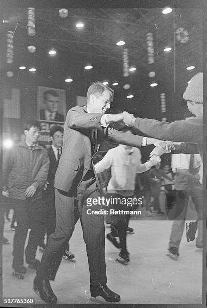 Attorney General Robert F. Kennedy and his wife were a tremendous hit as they glided around the indoor skating rink at Korakuen Ice Palace with...