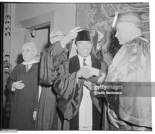 Indonesian president honored at Columbia. New York, New York: Indonesian president Sukarno is shown being invested by Dean Harry J. Carman of...