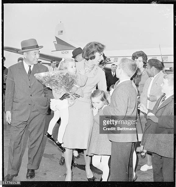 Attorney General and Mrs. Robert Kennedy received a kissing, hugging welcome home today from their seven children following a month-long,...