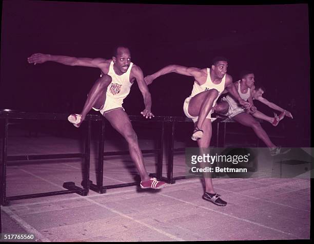 Manhattan, New York, New York: Harrison Dillard and Harry Nichols leaping over hurdles in second heat trial at KOC meet.