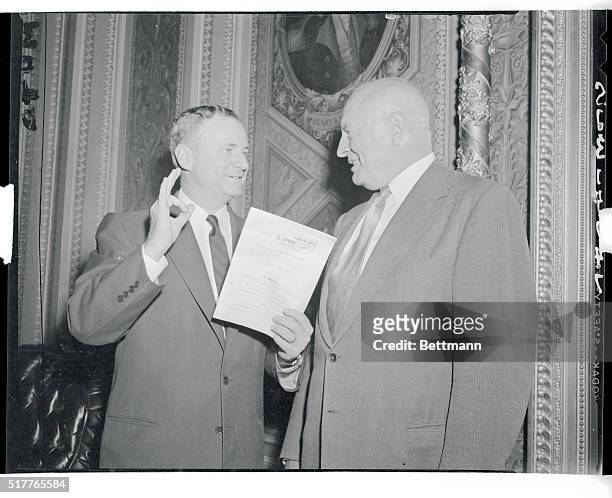 Senator Prince Daniel, Texas Democrat, gives the recognized hand signal for satisfaction as he chats with Commissioner of Narcotics Harry Anslinger...