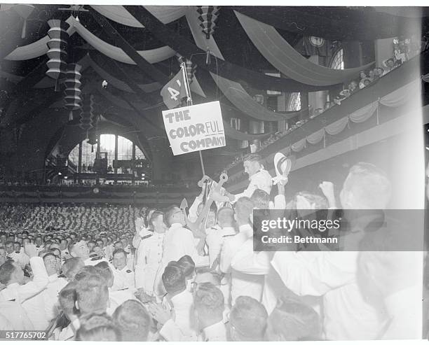 Annapolis, Maryland: James R. Visage, Chicago, Ill., anchor man of the 1956 graduating class of the United States Naval Academy is lifted to the...