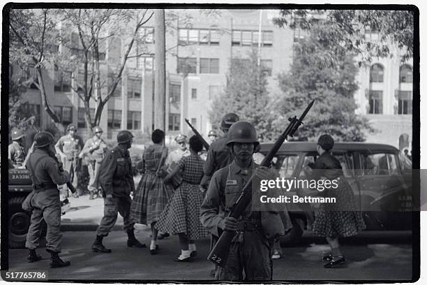 Negro students who had previously been barred from Little Rock Central High School, were provided with portal-to-portal protection in entering the...