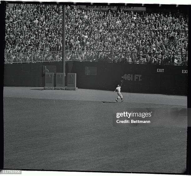 Yank's star center fielder Mickey Mantle is shown here as he misses Braves' Hank Aaron's long fly during the 2nd frame of the second series game at...