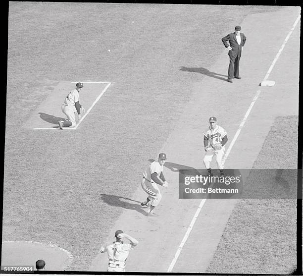 Mickey Mantle of the Yanks is trapped off third on Gil McDougald's bouncer to third in the third inning. Tag was finally applied by Matthews. Catcher...