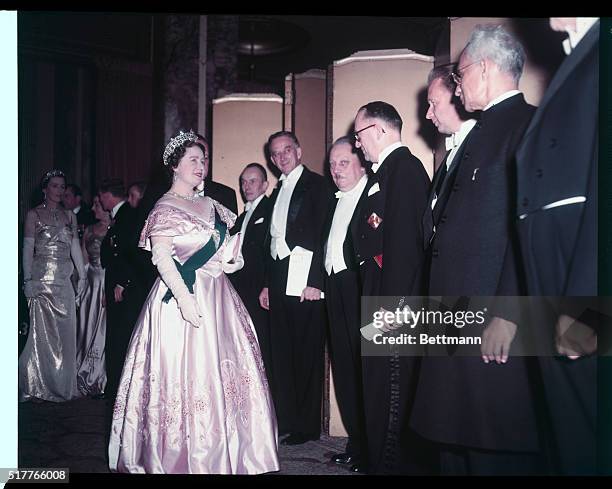 Queen Mother of England greets distinguished guests at the Charter day Dinner of Columbia Univ. Left to right: Queen Mother, Alberto Lleras Camargo,...