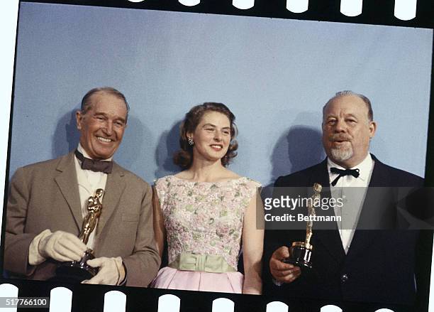 Ingrid Bergman with Burl Ives and Maurice Chevalier at Academy Awards Presentation. Burl Ives was the winner for Best Supporting actor and Maurice...