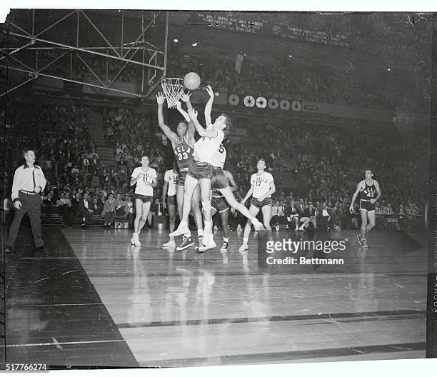 S Willie Naulls and La Salle's Fran O'Malley fight for a rebound in tonight's third annual ECAC Holiday Festival basketball game at Madison Square...