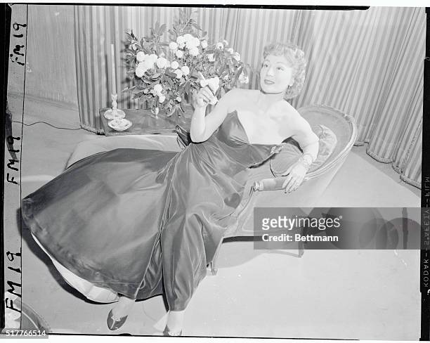 New York, New York: One of the three famous Gabor sisters, Magda, is shown on a chaise lounge rehearsing a scene in the production of This Thing...