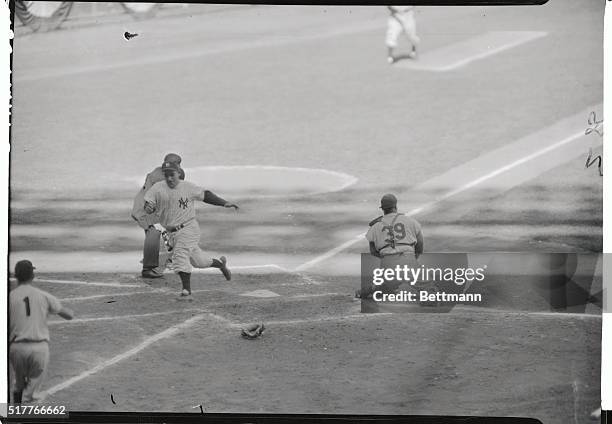 Yogi Berra of the Yanks scores on Howard's single in this fourth inning action of the second World Series game to spark the Yankee rally that found...