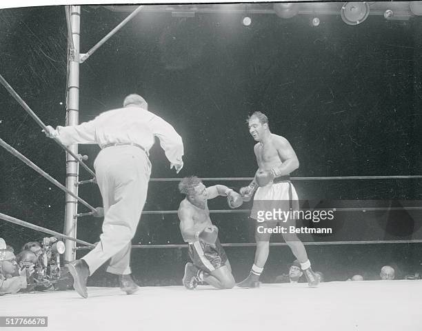 Contender Decked. New York, New York: Referee Harry Kessler rushes in to start the count as Rocky Marciano drops contender Archie Moore for the...