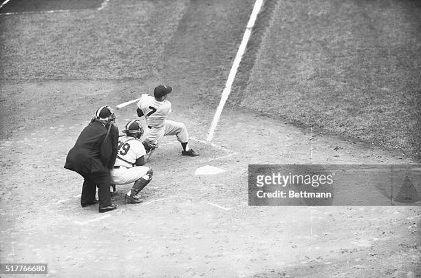Making his first trip to the plate in the 1955 World Series, Yankee Mickey Mantle follows through here after getting the fat part of the bat on the...