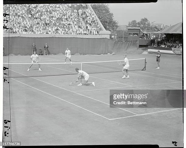 Aussies Return--Clinch Davis Cup. Forest Hills, New York: Lew Hoad of Australia, watches his partner Rex Hartwig making a backhand return during...