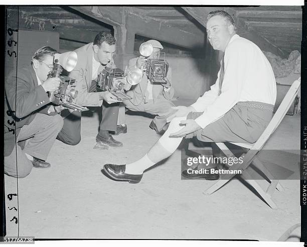 Clubhouse Quote -- "It's My Left Knee That's Hurt. . ." New York, New York: Dodgers' duke of swat, Duke Snider, shows his bandaged knee to press...