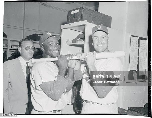The Duke of Swat. Brooklyn, New York: The Duke, a mighty man is he -- wields a mighty bat. Duke Snider smiles over the bat in dressing room after...