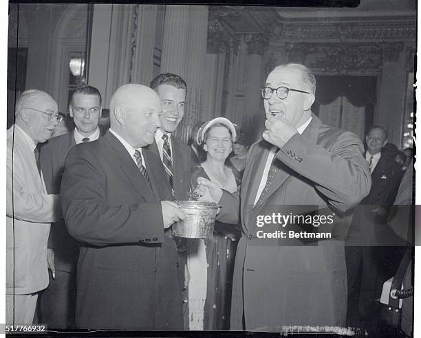 Washington, D.C.: Vladimir Matskevich, left, first deputy minister of Russian agriculture is shown serving caviar to U.S. Agriculture Secretary Ezra...