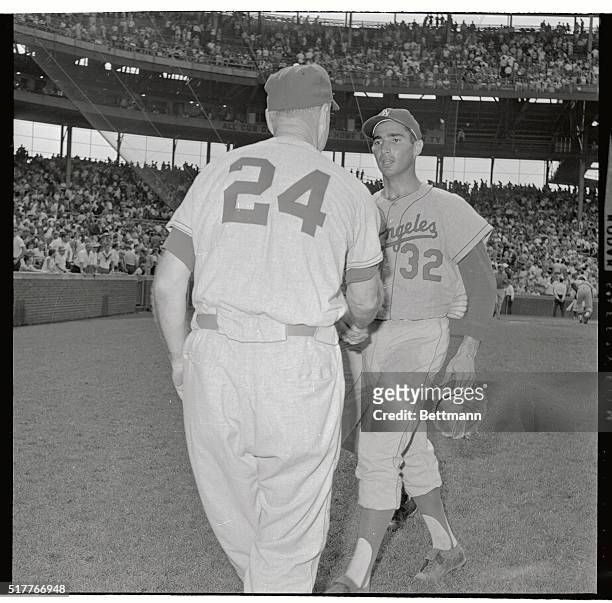 Los Angeles Dodgers manager Walt Alston is the first to congratulate Dodgers' pitcher Sandy Koufax as he comes off the mound after Dodgers beat Cubs,...