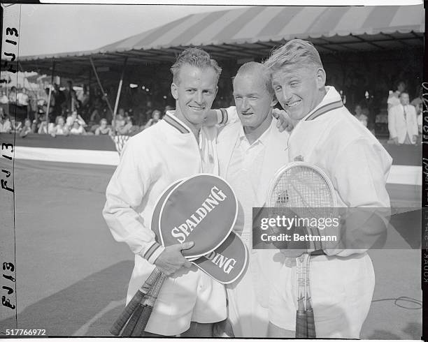 Rex Hartwig, and Lew Hoad, , are shown with non-playing captain Harry Hopman after winning today's double match, which clinched the Davis cup for...