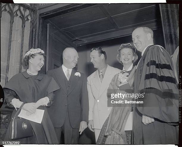Dwight and Mamie Eisenhower are shown talking and laughing with singer and actor Roy Rogers, along with Dale Evans and Reverend Edward L. R. Elson.
