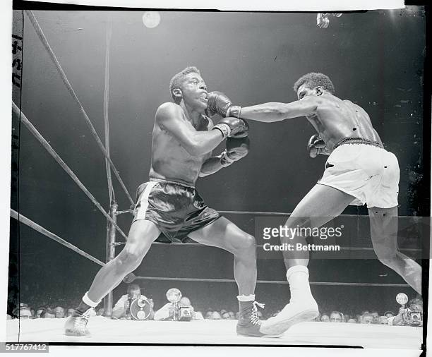 Long blow from the Hurricane. New York, New York: Tommy Jackson lands a long left to the chin of Floyd Patterson in the 10th round of their...