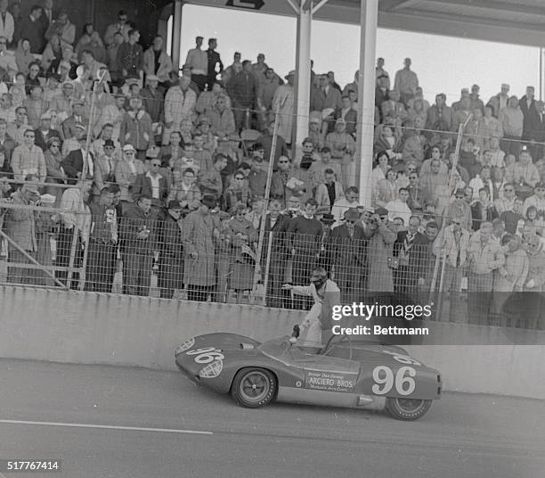 Daytona Beach, Fla.: Dan Gurney of Costa Mesa, Calif. Climbs back into his Lotus sports car after he broke his crankshaft. Gurney was in the last lap...