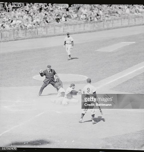 Streuli of the Detroit Tigers is out at home plate while trying to score from second in the third inning of the game against the New York Yankees at...