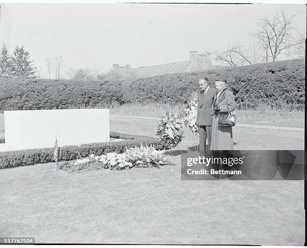 Gov. Averell Harriman and Mrs. Franklin D. Roosevelt pay tribute at the flower bedecked grave of the late President Roosevelt in Hyde Park today....