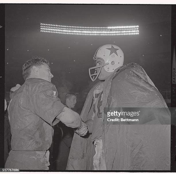 Washington Redskins halfback Dick James shakes hands with unidentified Dallas Cowboy after game.