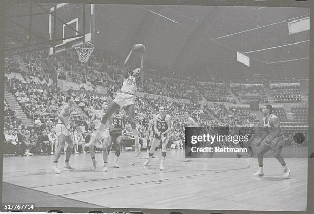 Hershey, Pa.: Philadelphia's Wilt Chamberlain looks for a landing spot after taking a rebound from Los Angeles during NBA match. Jim Krebs grimmaces,...