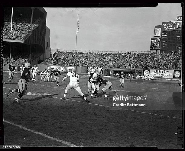 The Browns defeated the Steelers, 41-14, in their national pro game at Municipal Stadium this afternoon. Here "Old Man River" Otto Graham keeps...