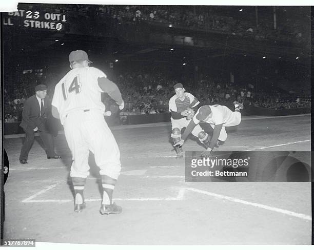 Roy Sievers, Nats' first baseman, makes like a football player while trying to score on the "tag-up" of a long fly ball hit by teammate Jim Lemon in...