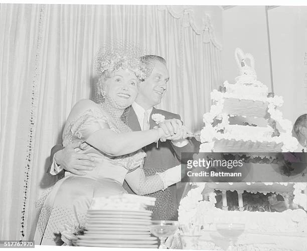 Mama Gabor a Bride. New York, New York: Jolie "Mama" Gabor, mother of the famed Gabor sisters, and her bridegroom, Edmund De Szigethy, cutting their...