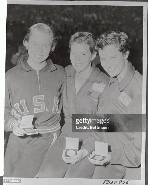 Olympic victors Karin Cone, Judy Grinham and Margaret Edwards display their medals after winning the women's 100 meter backstroke competition. Cone...