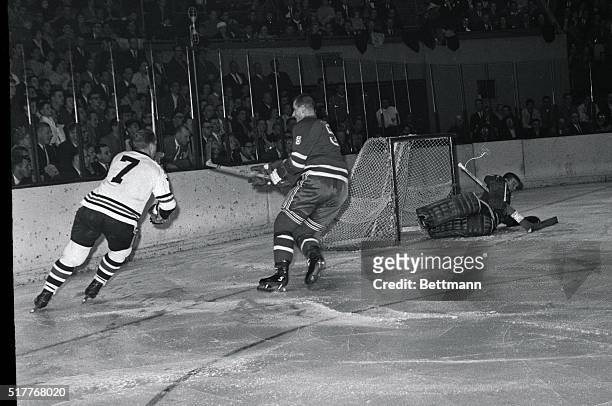 Chicago Black Hawks' Bobby Hull skates around the net after sinking puck in the goal past the sprawling New York Ranger goalie Lorne "Gump" Worsley...