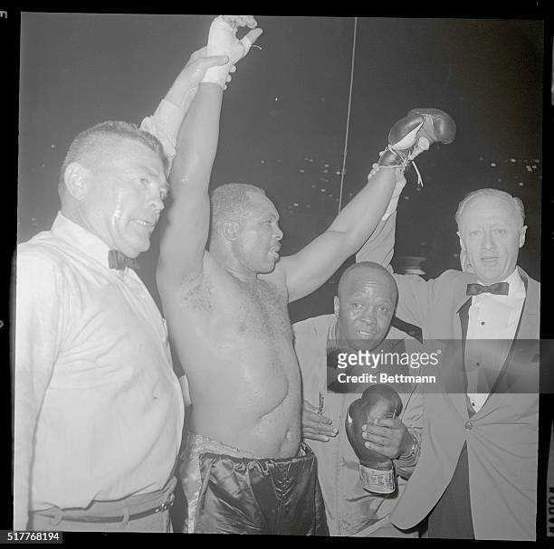 Los Angeles: Ageless Archie Moore waves to the crowd after his 10th round TKO of Argentine Alejandro Lavorante. Referee Tommy Moore pulled Lavorante...