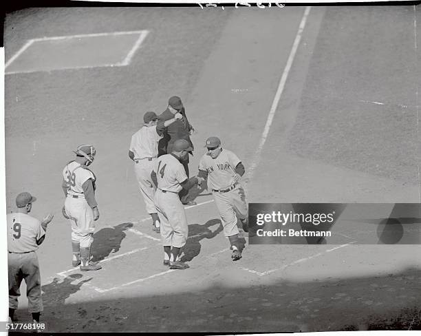 Yogi Berra of the Yankees is scoring on his first inning homer in the last game of the World Series at Ebbets Field. He drove Bauer in ahead of him...