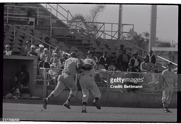 Bill White, St. Louis Cardinal's first baseman, , is tagged here by Philadelphia third baseman Don Demeter, after he was trapped between third and...