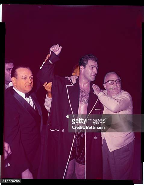 World heavyweight boxing champion Rocky Marciano raises his arm in the air after defeating Ezzard Charles here at Yankee Stadium.
