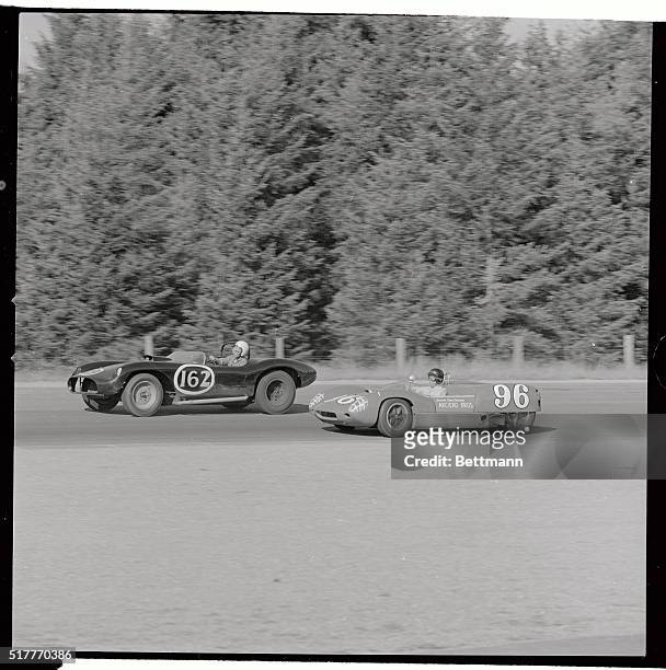 Seattle, Wash.: Dan Gurney driving a Lotus-19 Mote Garlo moves up on the inside to pass Don Jensen of Seattle driving a Pontiac Special, early in the...