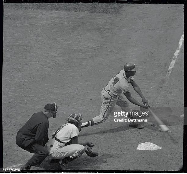 Hank Aaron of the Milwaukee Braves is shown hitting his 37th home run of the season in the 4th inning of the game against the Brooklyn Dodgers at...