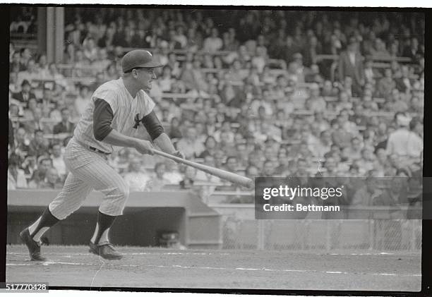 Slugger Roger Maris of the New York Yankees drives in a run against the Detroit Tigers 8/11 by bunting in first inning. Phil Linz scored from third...