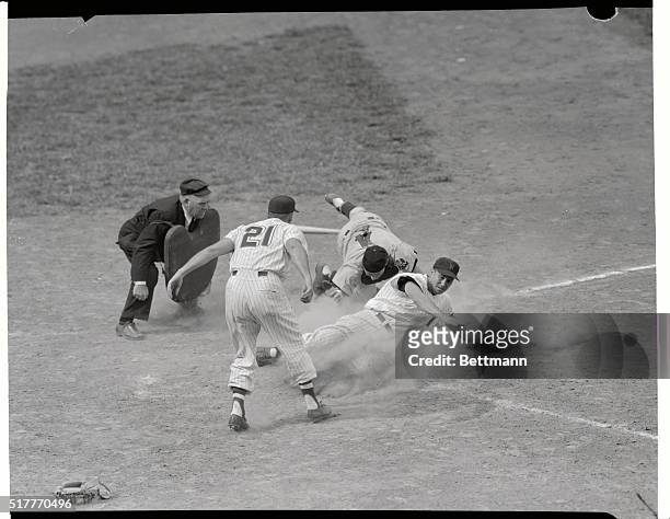 Roy Sievers slides safely into home, scoring the winning run from the 2nd base on a single to center field hit by pinch-hitter Ed Fitzgerald in...
