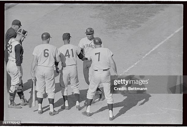 Willie Mays who returned to the lineup after being established for four days, is congratulated after hitting three-run homer in the eighth inning to...