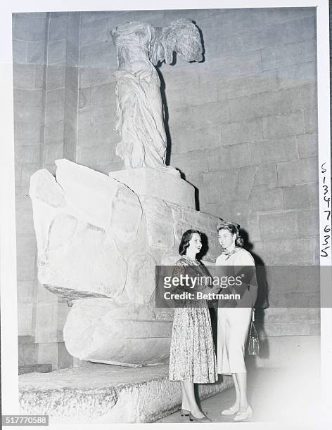 Jennie Ann and Ingrid Tour Louvre. Paris, France: Ingrid Bergman and daughter Jennie Ann stand in front of the statue of Victoire de Samothrace...