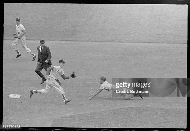 St. Louis, Missouri: Shortstop Maury Wills stealing his 96th base, dives headlong into 2nd to beat the throw from Cards catcher Carl Sawatski to ss...