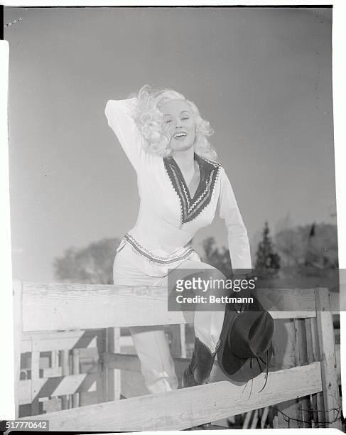 Actress Mamie Van Doren is learning to do trick riding for her part in her new movie Born Reckless, in this photograph. She is wearing a western...